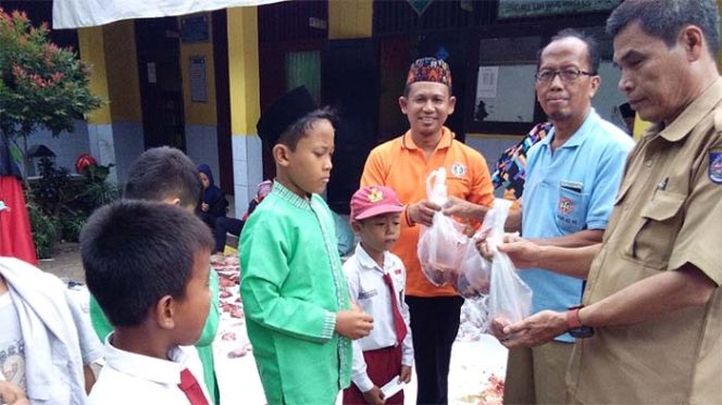 
					Guru secara simbolis memberikan daging kurban kepada siswa yatim di SDN Pondok Petir 01.